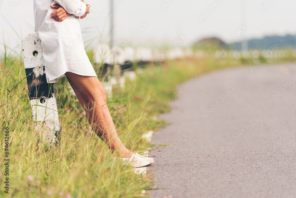 Woman traveller walking on road relaxation. Women wear sneaker shoes walking on summer park. Females standing in green park on forest pathway outdoors. Young traveler relaxing vacation in walk way - obrazy, fototapety, plakaty 