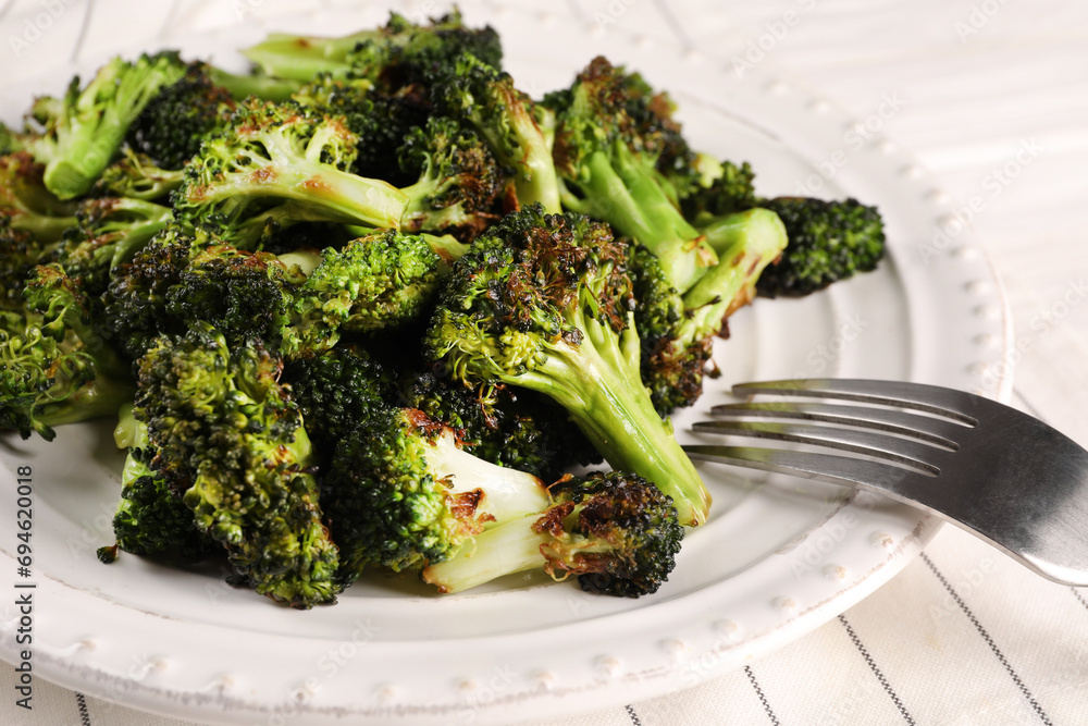 Tasty fried broccoli and fork on table, closeup Tasty fried broccoli and fork on table, closeup