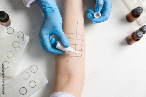 Doctor doing skin allergy test at light table, top view photo