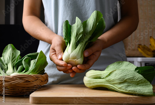 Bok choy or Pak choi (Chinese cabbage) with woman hand prepare for cooking, Organic vegetables photo