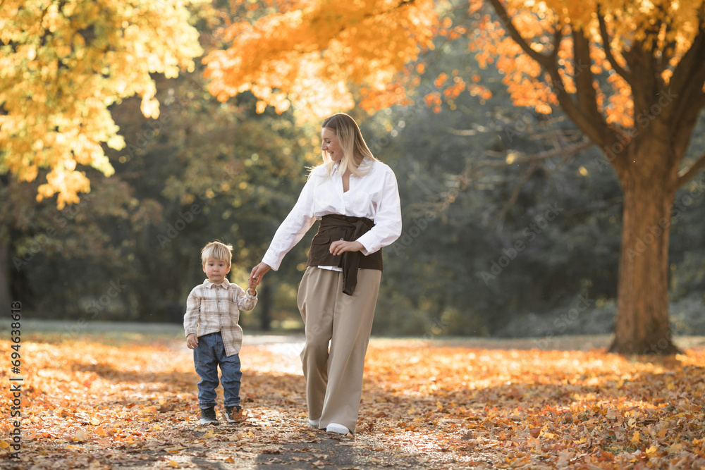 Mothers day, love family. Family on autumn walk in nature outdoors. Mother and child with hugging tenderness Mothers day, love family. Family on autumn walk in nature outdoors. Mother and child with hugging tenderness