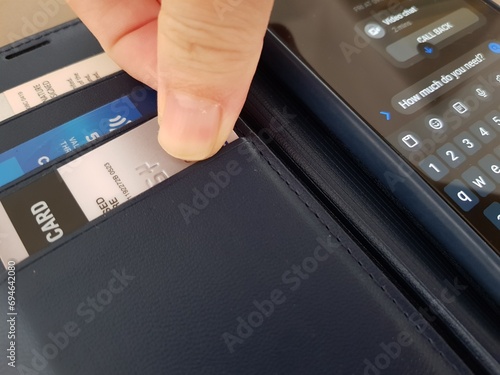 Getting ready a credit card and off focus of text message the words 