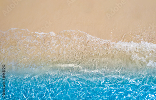 Aerial view of the beach and water on the island. During the summer the sun hits the sandy beach. Sparkling sea water. For a summer vacation idea. 