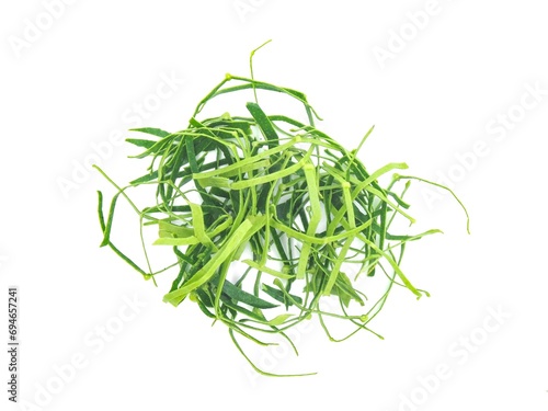 Fresh organic kaffir lime leaves, no chemicals, cut into pieces as a cooking ingredient. Green leaves, placed on a white background.