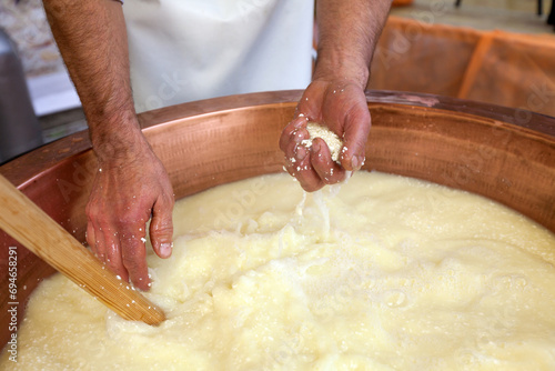 Diary Farm Close Up of Cheese Making Artistry: Hands expertly blend Milk, Cultures, and Rennet in Heating All Together in a Copper Boiler, Crafting Artisanal Dairy Product - Cheese