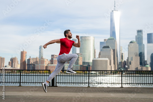 Sports man doing sport on street. Runners sprinting outdoors. Sportsman training in a urban area, healthy lifestyle sport. Sport man jogging in New York City. Outdoor Sport. Sports wear for runners.