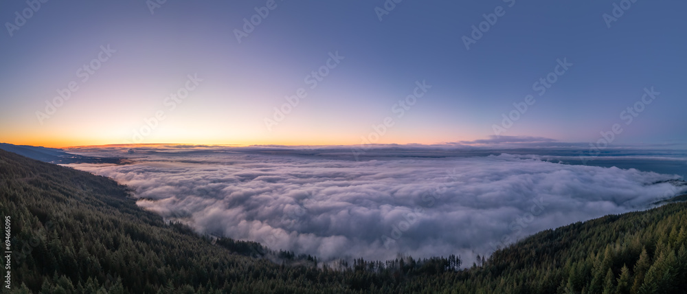 Clouds covering Canadian Mountain Landscape. Aerial Background