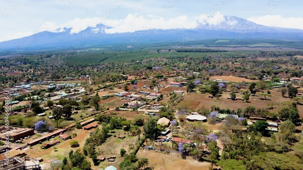 rural village town of kenya with kilimanjaro in the background. Aerial cityscape Mount Kilimanjaro. rural village town of kenya with kilimanjaro in the background. Aerial cityscape Mount Kilimanjaro.