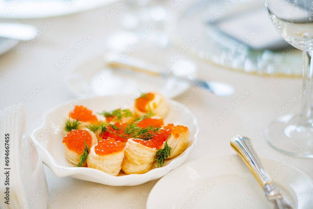 canape with red caviar on table canape with red caviar on table