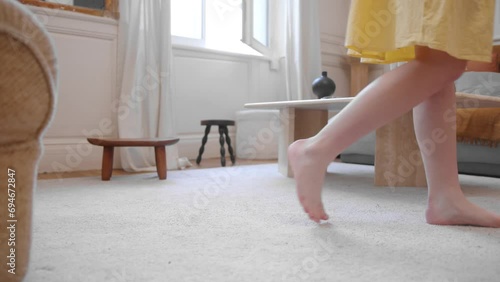 Barefooted Woman In Yellow Mini Dress Walking In A Living Room. Close-up Shot