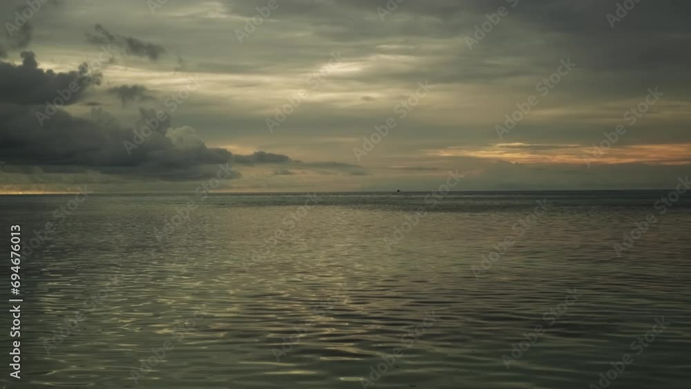 Calm waves of the sea during sunset. Beautiful pre-storm cloudy sky on the background. Calm waves of the sea during sunset. Beautiful pre-storm cloudy sky on the background.