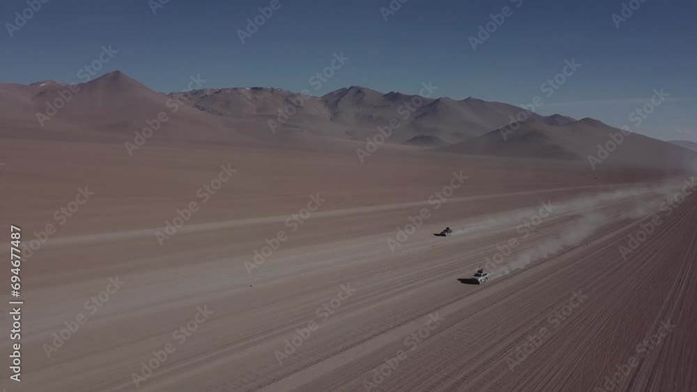 Two vehicles driving parallel through the Salvador Dalí Desert in Bolivia. Two vehicles driving parallel through the Salvador Dalí Desert in Bolivia.