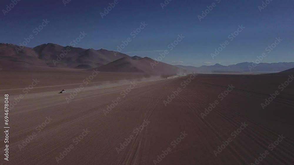 Aerial shot of vehicles traversing through the Salvador Dalí Desert in Bolivia. Aerial shot of vehicles traversing through the Salvador Dalí Desert in Bolivia.