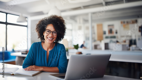 Creative Designer Woman Wearing Glasses Working in a Modern Office Smiling at the Camera photo