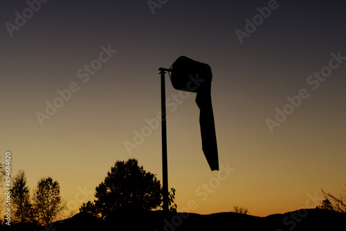 Airport windsock on a pole during sunset photo