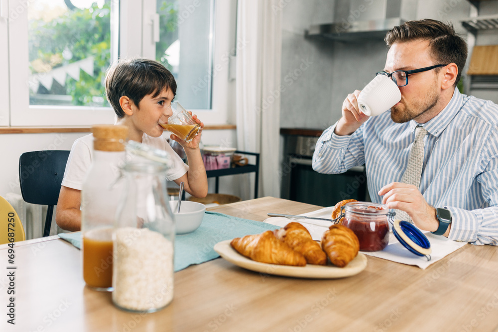 Young Caucasian boy s having breakfast with his father. Young Caucasian boy s having breakfast with his father.