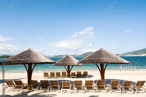 Beach lounges and umbrellas on the beach. © zhennyzhenny