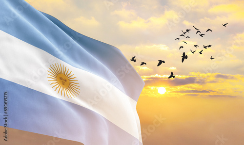 Fotografie Waving flag of Argentina against the background of a sunset or sunrise