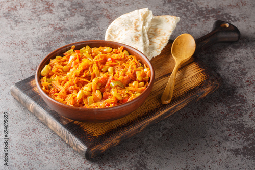 Chakalaka Spicy Vegetable Relish with carrot, baked bean, onion, tomato, pepper closeup on the bowl on the table. Horizontal