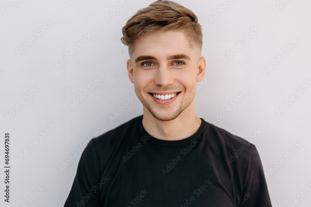 closeup photo portrait of a handsome blonde scandinavian man smiling with clean teeth. for a dental ad. closeup photo portrait of a handsome blonde scandinavian man smiling with clean teeth. for a dental ad.