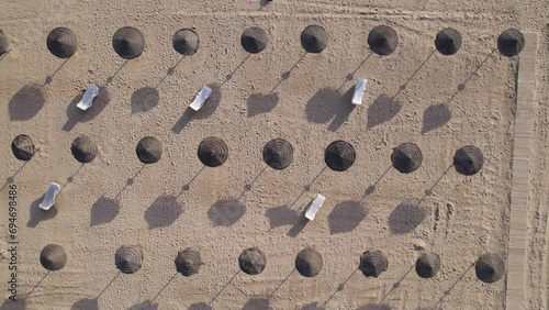 Aerial top view of beach umbrellas and sunbeds photo