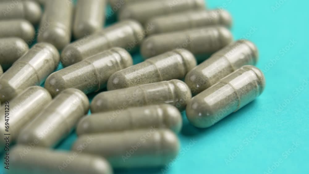 White medication pills on a blue background. Healthcare medicament concept. Rotation White medication pills on a blue background. Healthcare medicament concept. Rotation
