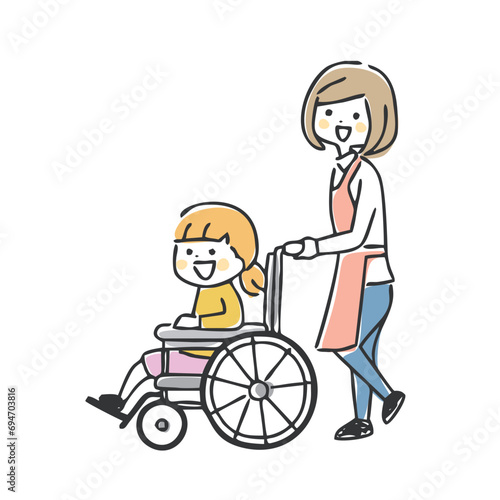 車椅子の女の子と女性スタッフ
