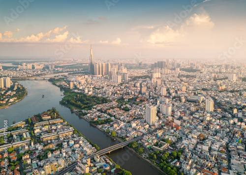 Fototapeta Naklejka Na Ścianę i Meble -  Panoramic view of Saigon, Vietnam from above at Ho Chi Minh City's central business district. Cityscape and many buildings, local houses, bridges, rivers