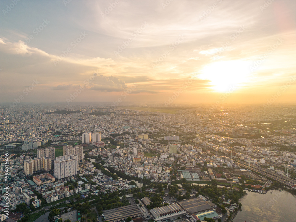 Panoramic view of Saigon, Vietnam from above at Ho Chi Minh City's central business district. Cityscape and many buildings, local houses, bridges, rivers