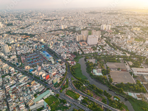 Panoramic view of Saigon, Vietnam from above at Ho Chi Minh City's central business district. Cityscape and many buildings, local houses, bridges, rivers