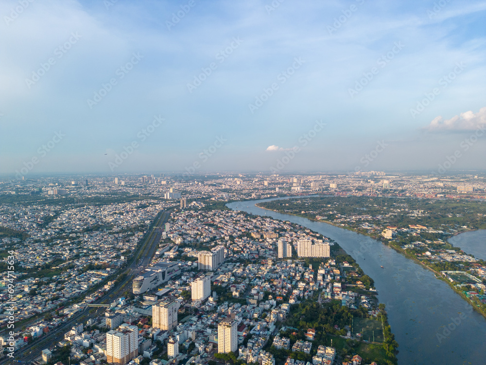 Fototapeta premium Panoramic view of Saigon, Vietnam from above at Ho Chi Minh City's central business district. Cityscape and many buildings, local houses, bridges, rivers