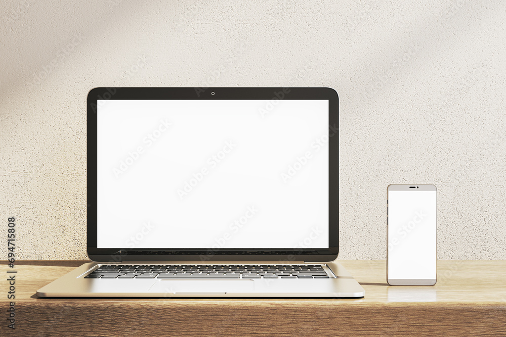 Close up of empty white laptop and smartphone on wooden desk. Concrete wall background. Device presentation and online education concept. Mock up, 3D Rendering. Close up of empty white laptop and smartphone on wooden desk. Concrete wall background. Device presentation and online education concept. Mock up, 3D Rendering.