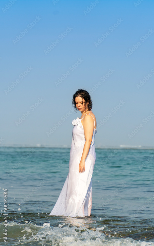 Beautiful bride in a white wedding dress on the seashore Beautiful bride in a white wedding dress on the seashore