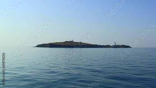 Slow approach to Snake Island on the horizon. Black Sea, Ukraine. photo