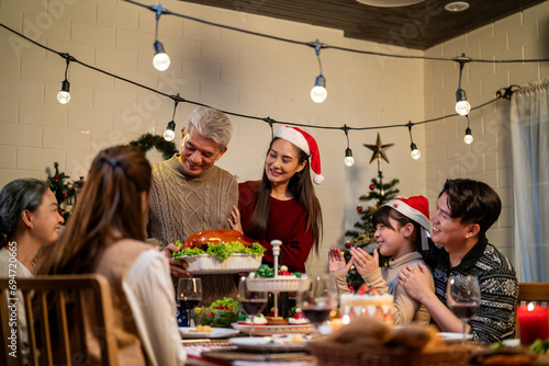 Asian lovely family celebrating Christmas party together in house. 