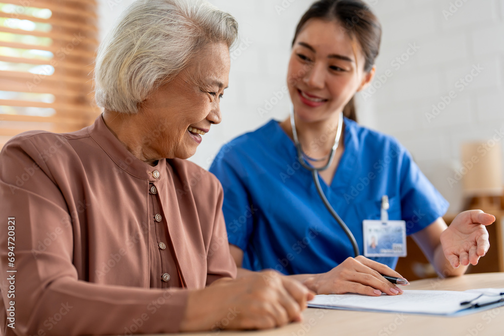 Asian young caregiver nurse examine senior woman patient at home. Asian young caregiver nurse examine senior woman patient at home.