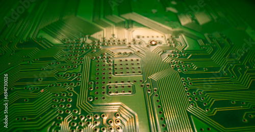 Circuit board. Technological electronic plate with roads and other components, selective focus. Technology background, electronics texture. photo