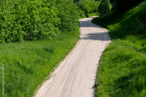 a narrow country road in the summer