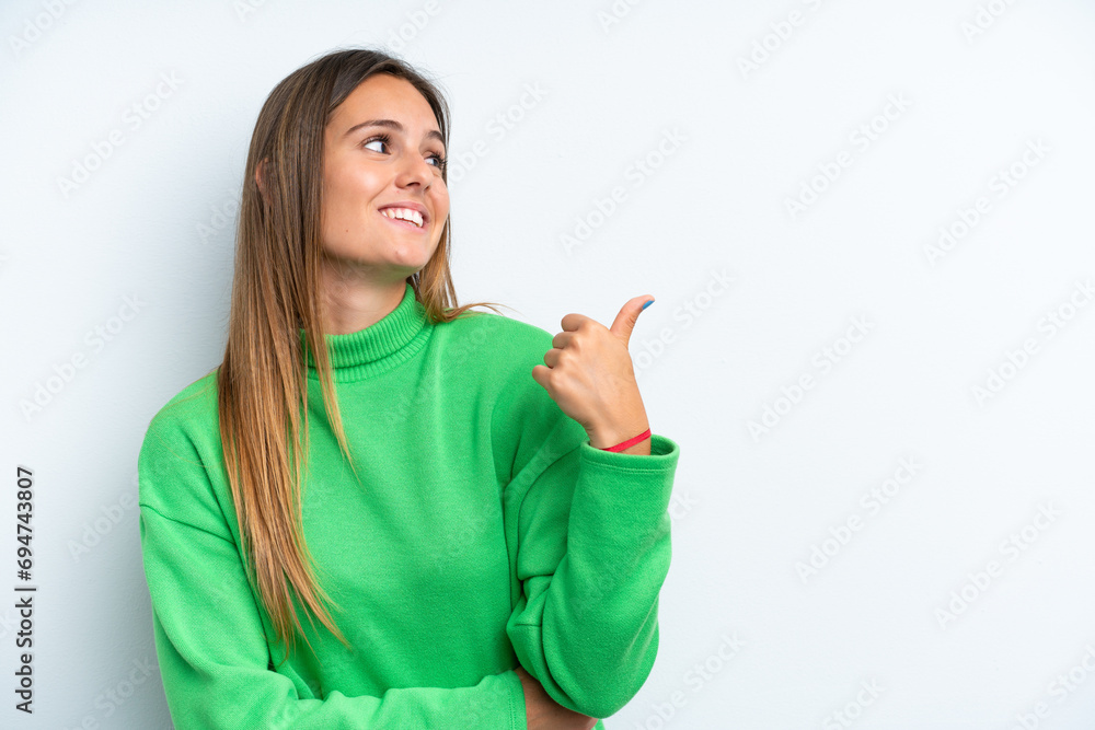 Young caucasian woman isolated on white background pointing to the side to present a product Young caucasian woman isolated on white background pointing to the side to present a product