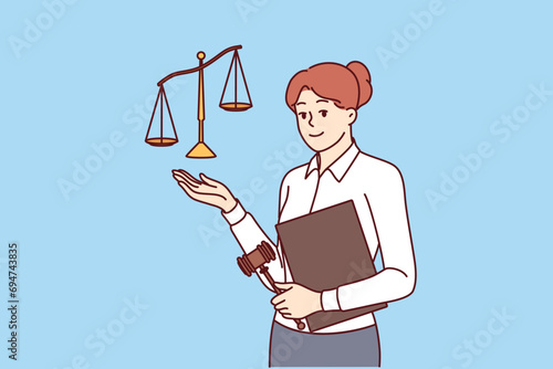 Woman lawyer working in law office holds gavel and scales symbolizing justice or jurisprudence. Young girl lawyer offers to use services for solving legal problems and patent disputes