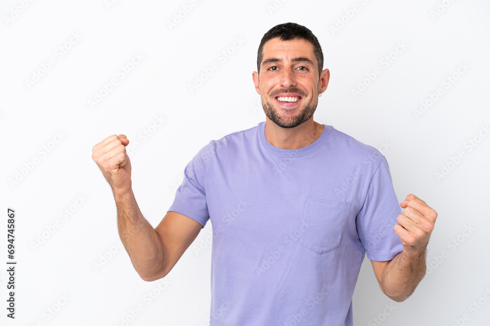 Young handsome caucasian man isolated on white background celebrating a victory Young handsome caucasian man isolated on white background celebrating a victory
