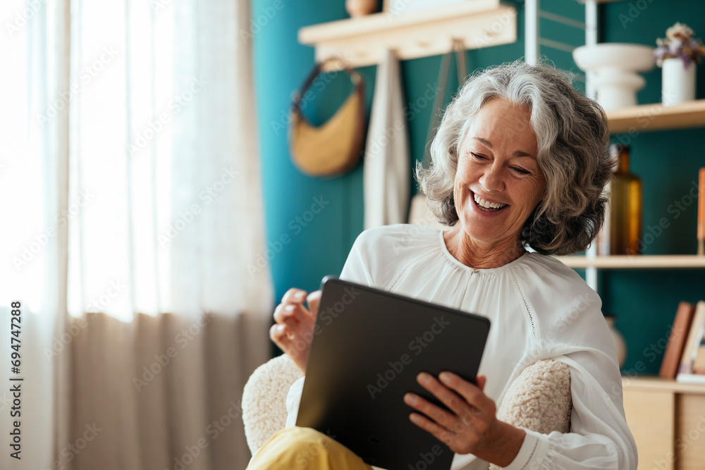 © Westend61 - Happy psychologist using tablet PC and sitting at home