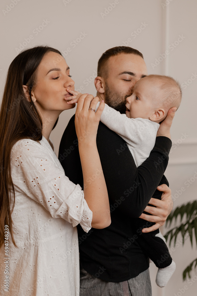 Loving parents kissing son at home Loving parents kissing son at home