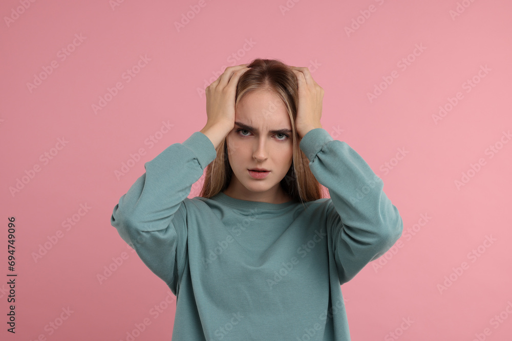 Portrait of resentful woman on pink background Portrait of resentful woman on pink background