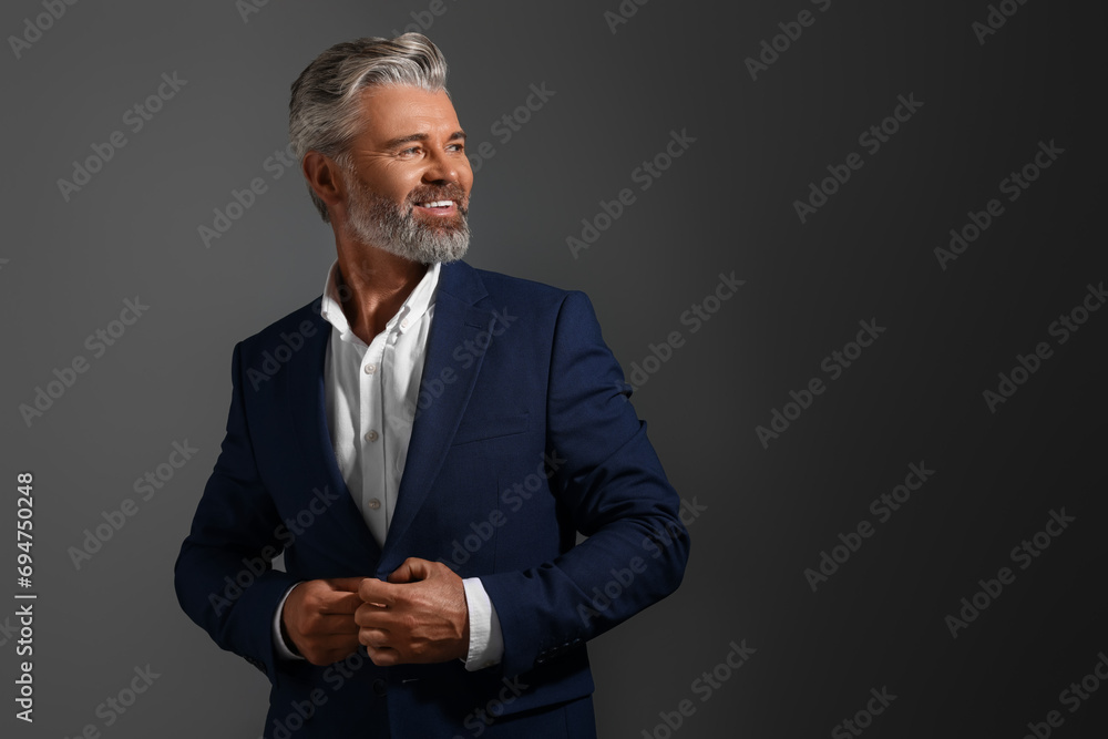 Portrait of smiling man with beautiful hairstyle on dark background. Space for text Portrait of smiling man with beautiful hairstyle on dark background. Space for text