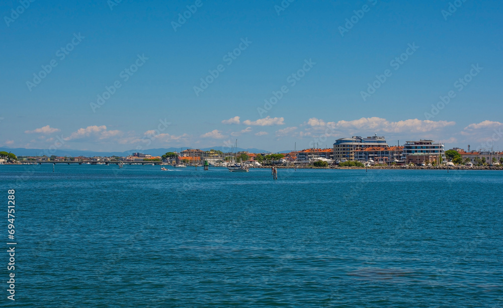 The coastal holiday resort town of Grado in Friuli-Venezia Giulia, north east Italy. Viewed from the Marano and Grado Lagoon in August