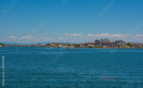 The coastal holiday resort town of Grado in Friuli-Venezia Giulia, north east Italy. Viewed from the Marano and Grado Lagoon in August