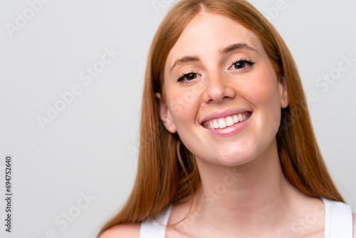 Portrait of pretty redhead woman over isolated white background