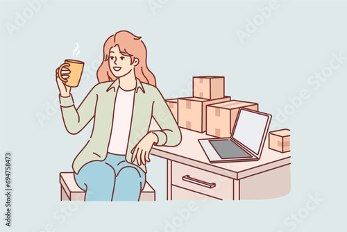 Woman small business owner drinks coffee sitting at table with boxes, takes short break. Girl is engaged in fulfillment business and prepares goods ordered in online store for shipment.