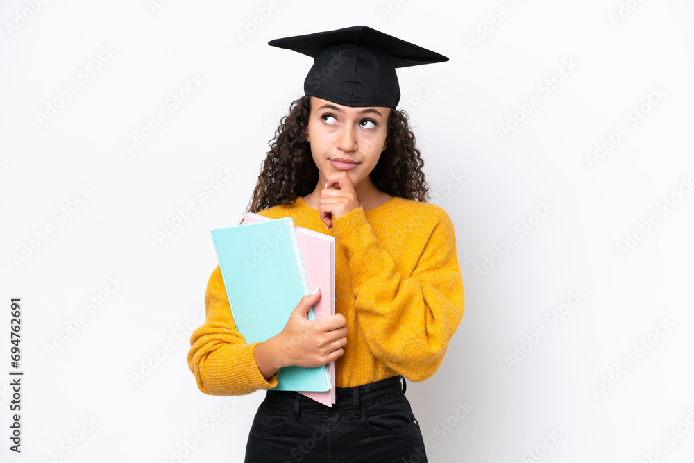 Arab university graduate woman holding books isolated on white background and looking up Arab university graduate woman holding books isolated on white background and looking up